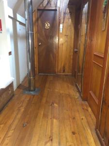 a hallway with a large wooden door in a building at Patagonia Nice View in Puerto Montt