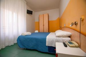 Postel nebo postele na pokoji v ubytování Hotel Montebello Riccione