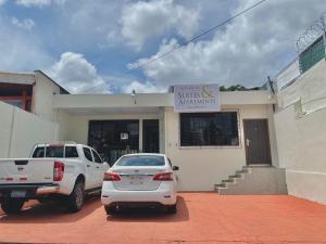 un coche blanco estacionado frente a un edificio en Hotel La Capilla - Suites & Apartments San Benito, en San Salvador