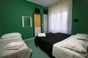 Postel nebo postele na pokoji v ubytování Hotel Montebello Riccione