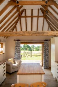 a living room with a wooden table and a couch at The Cowshed in Hooe