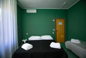 Postel nebo postele na pokoji v ubytování Hotel Montebello Riccione
