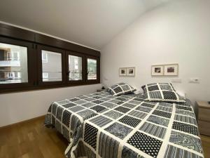 a bedroom with a bed with two pillows on it at APARTAMENTO El Roxu 2 in Arriondas