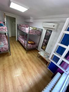 a room with bunk beds and a wooden floor at Hostal Madrid Paradise in Madrid