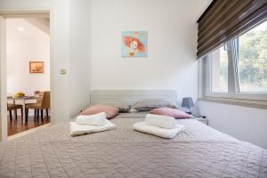 a bedroom with a large bed with two pillows on it at Ivano in Ston