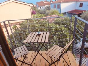 a balcony with two chairs and a table on a deck at Guests house DaLi in Rovinj