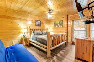 a log cabin bedroom with a bed and a couch at Valhalla Manor in Pigeon Forge