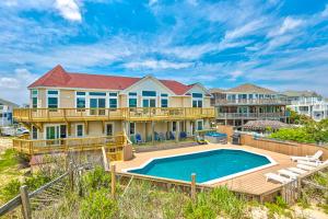 a house with a swimming pool and a deck at Sea Esta 404 in Corolla