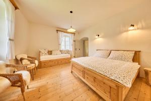 a bedroom with a large wooden bed and a couch at Chalupa Fara in Dolní Malá Úpa