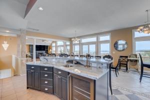 a kitchen with a large island with two sinks at Sea Esta 404 in Corolla