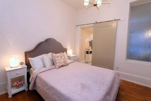 a bedroom with a bed and a window and a lamp at Queen Anne's Condo in Savannah