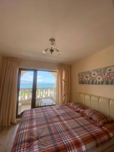 a bedroom with a bed and a large window at Summertime in Varna South Bay Beach Residence in Varna City +83 photos