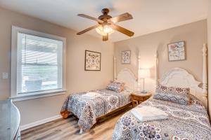 a bedroom with two beds and a ceiling fan at Sea Esta 404 in Corolla