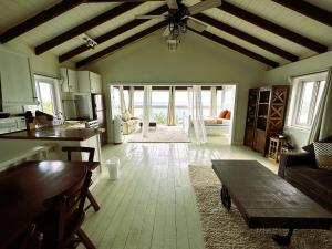 a kitchen and living room with a table and a couch at MIRAMAR SUITES in West End