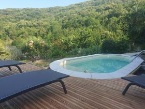 a hot tub on a deck with a view of a mountain at La Storya in Meyras