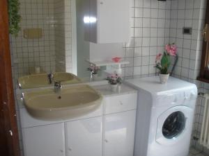a bathroom with a sink and a washing machine at Casa Variante in Cannobio