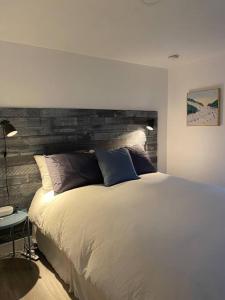 sypialnia z dużym łóżkiem z drewnianym zagłówkiem w obiekcie Newly Renovated Catskill Getaway w/ Hot Tub w mieście Fleischmanns