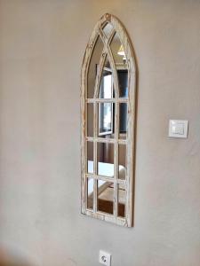 a mirror with a wooden frame on a wall at Theater Penthouse in Corfu Town