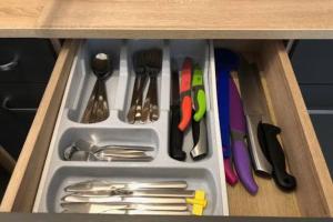 Un cajón lleno de utensilios en un armario. en Erfurt City -Schildchensmühle, en Erfurt