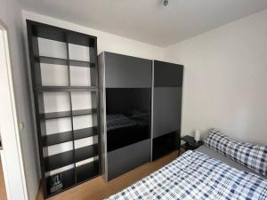 a bedroom with a bed and a glass cabinet at Erfurt City -Schildchensmühle in Erfurt