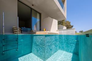 a swimming pool in front of a house at Olive Garden Hotel in Lartos