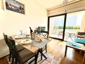 a dining room with a table with food on it at Fides Stylish Apartments Tivat with Pool in Tivat