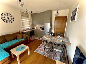 a living room with a couch and a table at Fides Stylish Apartments Tivat with Pool in Tivat