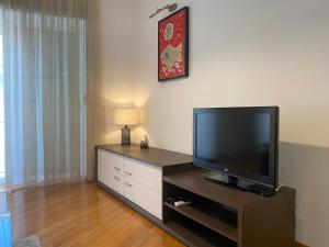 a living room with a flat screen tv on a table at Apartments Skiljan in Crikvenica