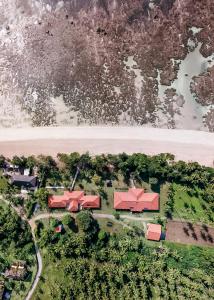 an aerial view of a house with red roofs next to a river at Pousada Caeira in Morro de São Paulo