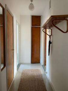an empty hallway with a door and a rug at Aalto Apartments Sunila Honkala 2 in Kotka