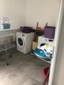 uma lavandaria com uma máquina de lavar roupa e uma máquina de lavar roupa em Location appart 5 chambres, 5 SDB - TUAMOTU - 8 pers em Le Bourget-du-Lac