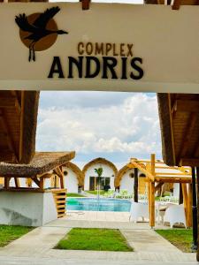 a sign for a resort with a swimming pool at Complex Andris in Murighiol