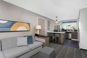 a living room with a couch and a kitchen at Hyatt House San Juan in San Juan