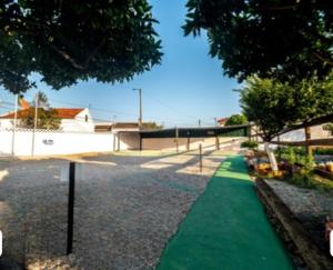 a playground with a green path in a park at VILA NATURA in Barreiro