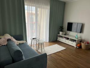 a living room with a couch and a flat screen tv at Apartment Kvartsi in Tartu