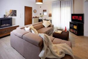 a living room with a couch and a tv at Elegance and comfort a due passi da SACILE CENTRO in Sacile