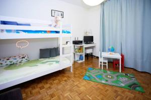 a bedroom with two bunk beds and a desk at Elegance and comfort a due passi da SACILE CENTRO in Sacile