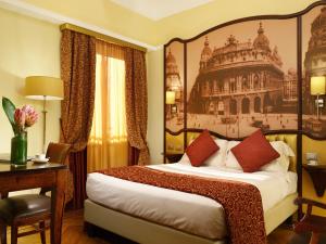 a hotel room with a bed and a painting on the wall at Grand Hotel Savoia in Genoa
