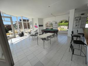 a room with a pool table and tables and chairs at Apartaments Monjardí in Lloret de Mar