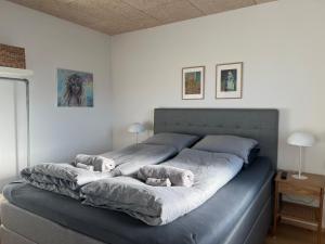 a large bed with two stuffed animals on it at Atlantic Jewel in Tórshavn