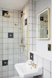 a white bathroom with a sink and a mirror at Railway House York by Chateau Anna in York +112 photos