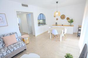 a living room with a table and a couch at LITORAL COSTA DORADA - SOL MEDITERRANI ático in Cambrils