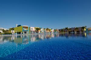 a large pool of blue water with buildings in the background at Orada Apartamentos Turísticos - Marina de Albufeira in Albufeira