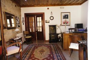 a living room with a table and chairs and a door at Quinta Calcaterra in Marialva