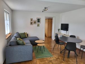 a living room with a couch and a table at Les petits Rosiers in Tramelan