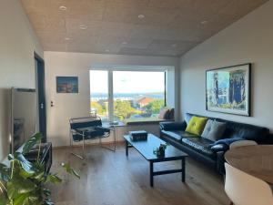 a living room with a couch and a table at Atlantic Jewel in Tórshavn