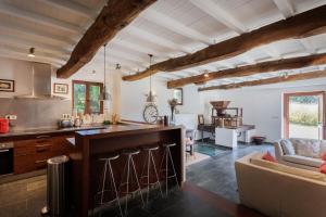 a kitchen with a counter and a living room at Eco molino rural in Santa Eulalia