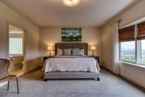 a bedroom with a bed and two windows at Love View in Sevierville
