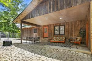 a porch of a wooden house with chairs and tables at Knot A Kabin in Pigeon Forge