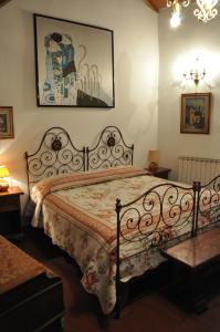 a bedroom with a bed and a picture on the wall at La Fattoressa in Florence